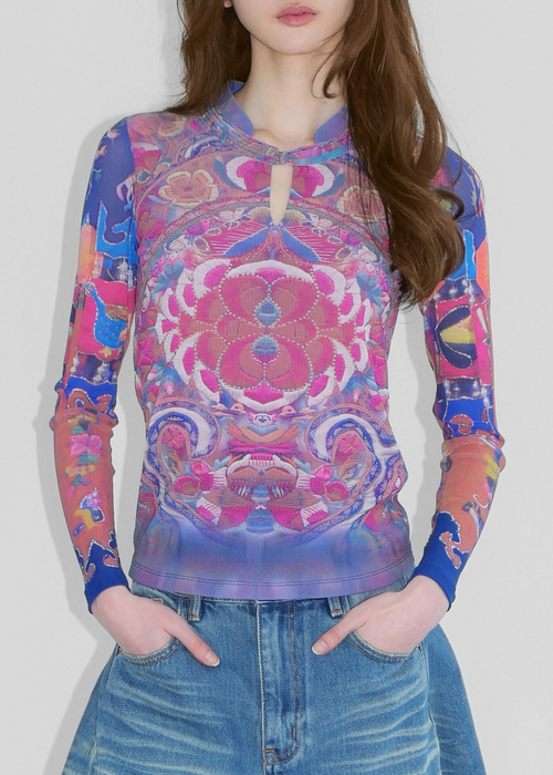 A model wearing Chinese style print in blue and pink mesh top with madarin collar and chinese knot fastening and denim shorts