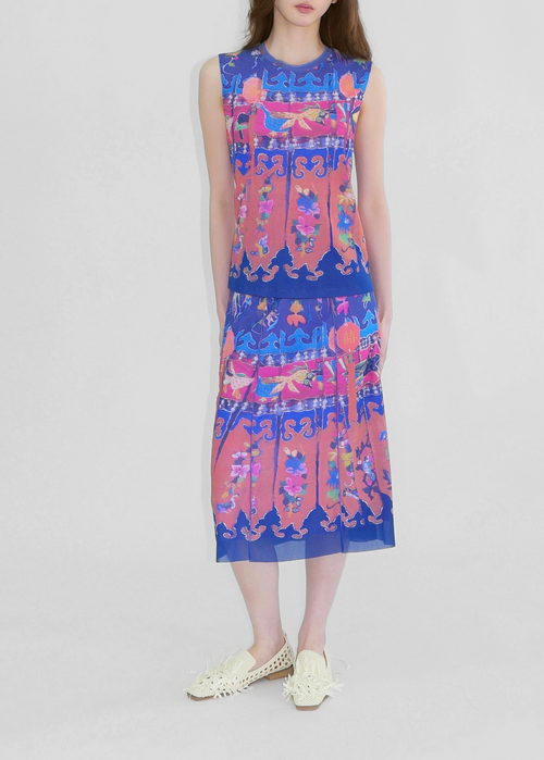 Woman wearing a colorful sleeveless dress on a white background