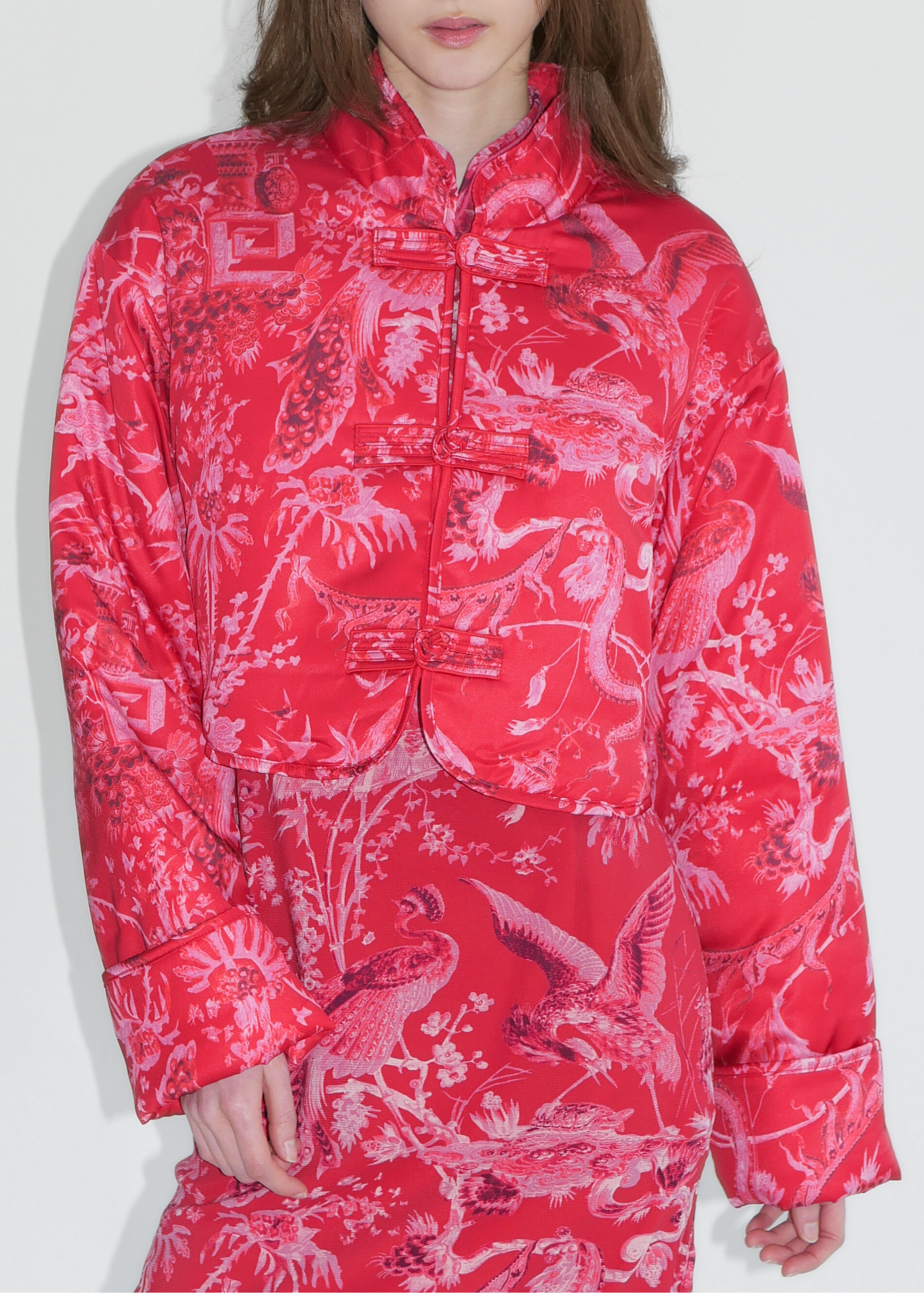 Person wearing a red patterned outfit on a white background