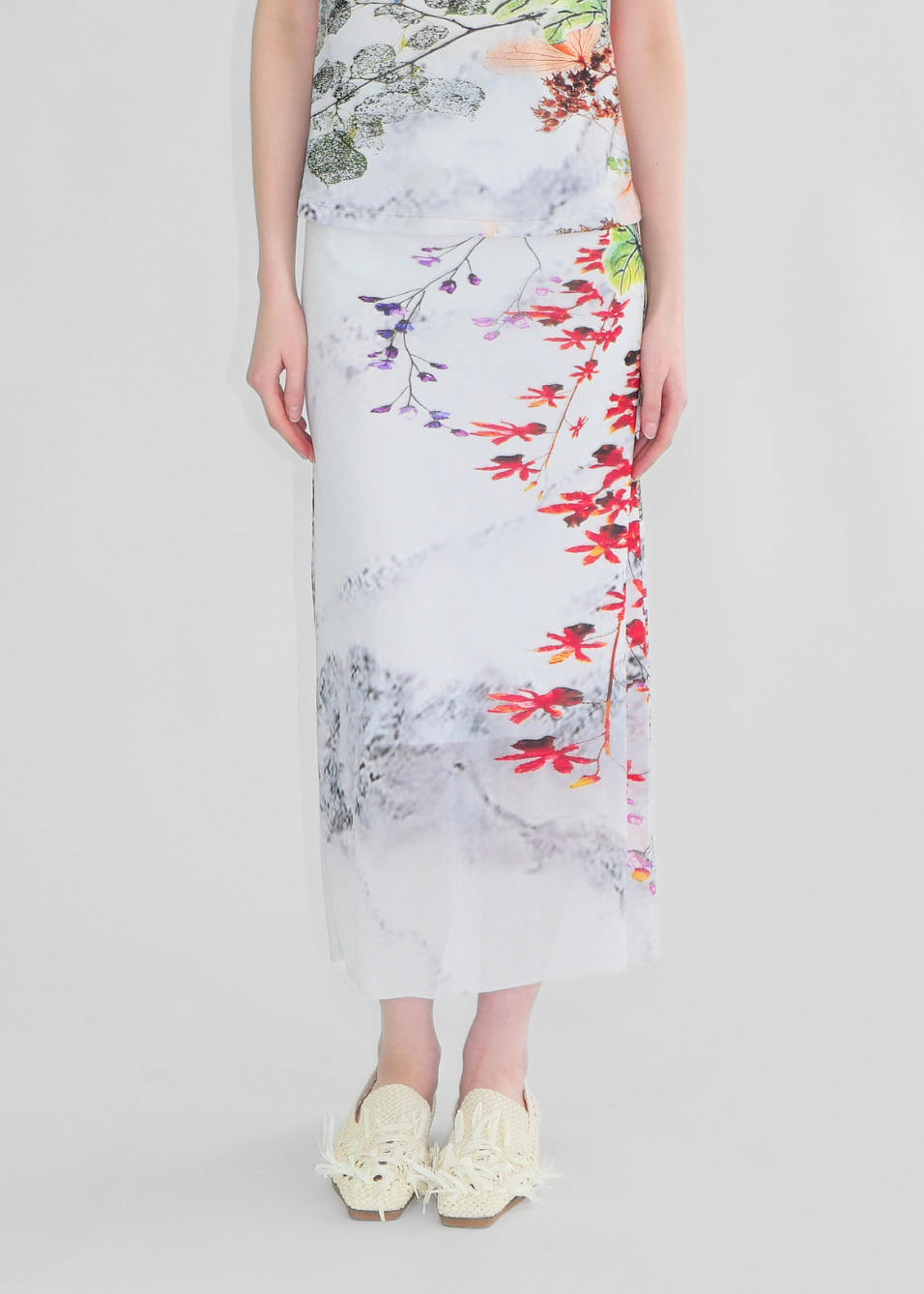 Woman wearing a floral dress with a white background