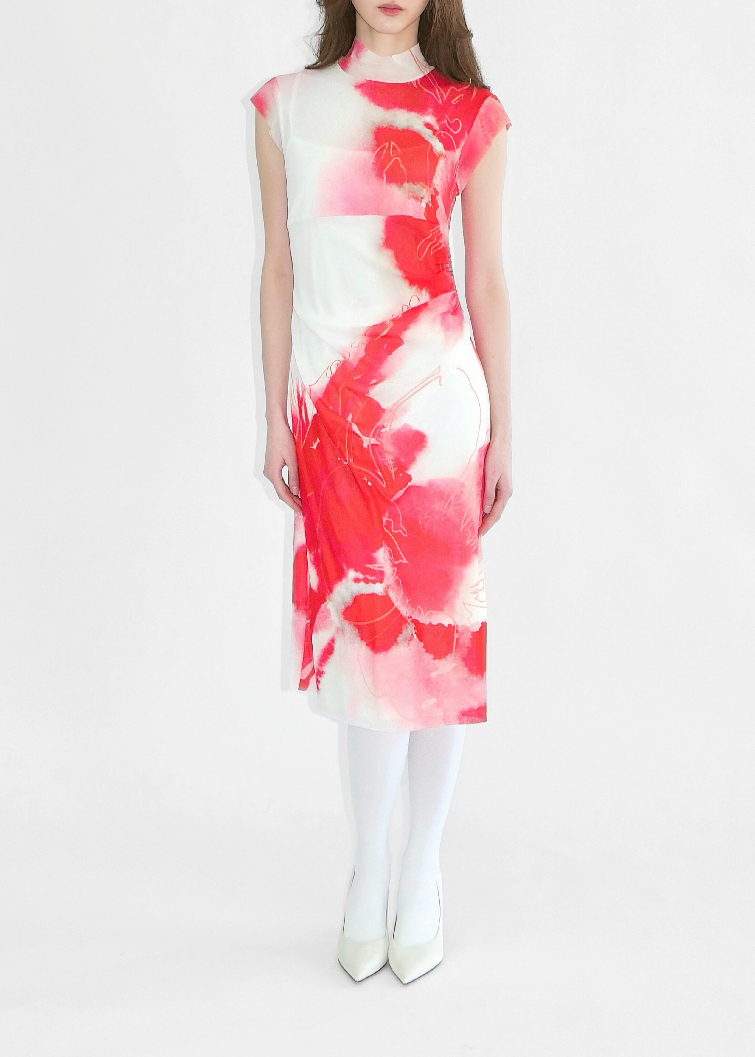 Woman wearing a red and white floral dress on a white background