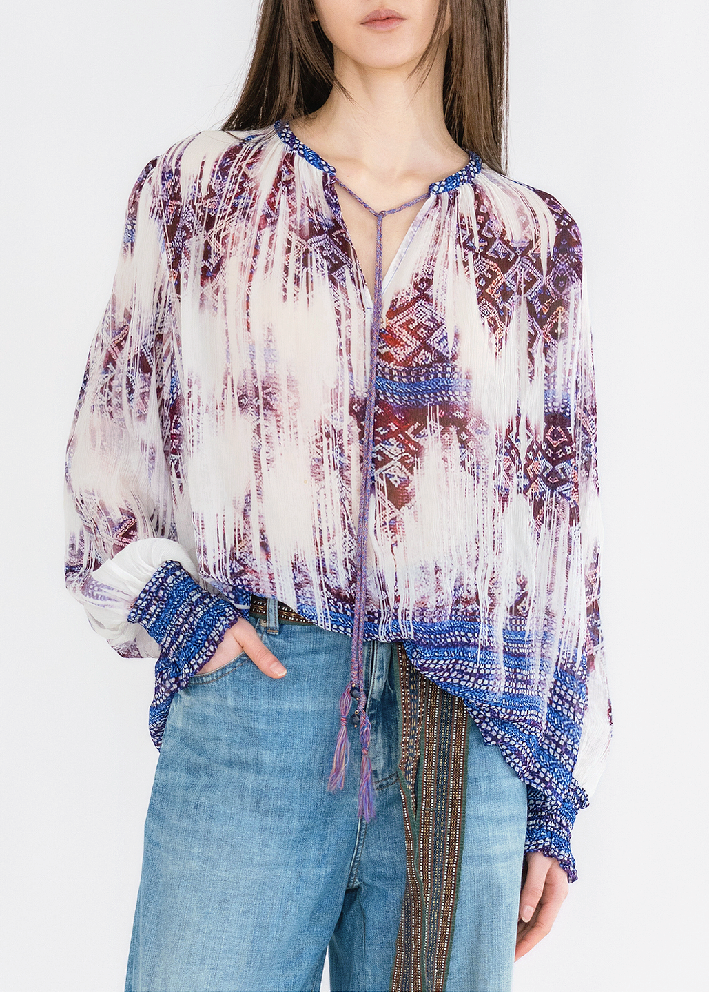 A model wearing a multicolored, faded brocade print crinkle viscose blouse with long sleeves and a round neckline.