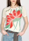 Woman wearing a t-shirt with a red floral design on a plain background