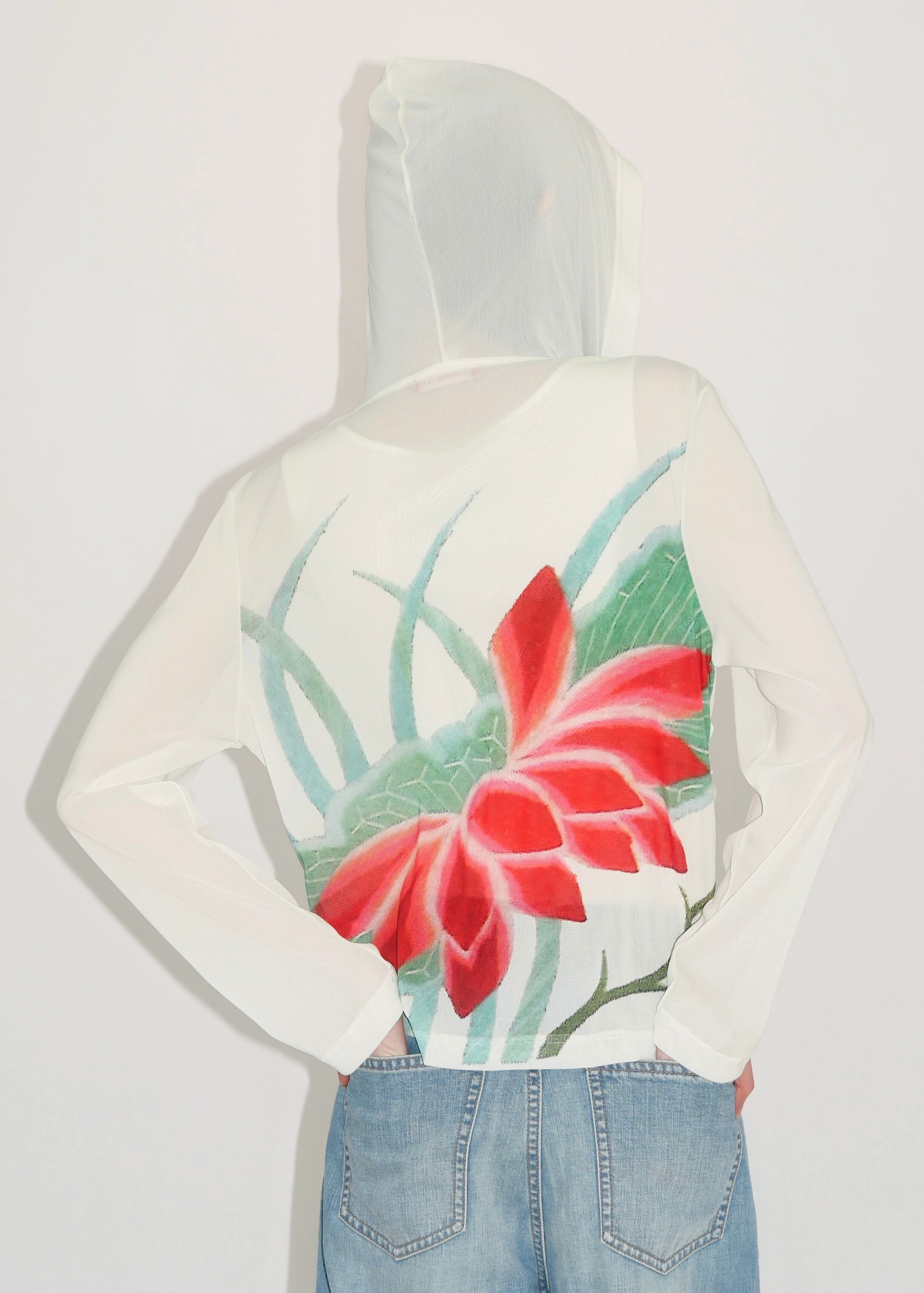 White hoodie with red floral design on a plain background