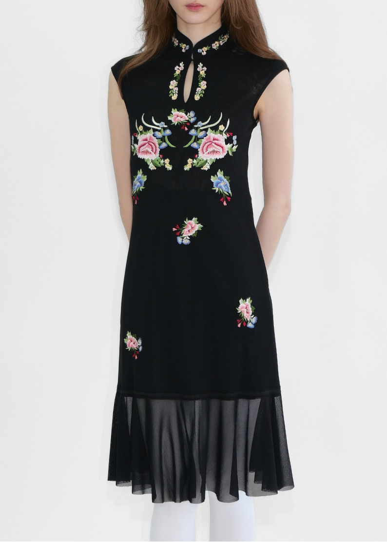 Black dress with floral embroidery on a white background