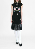 Black sleeveless dress with floral embroidery on a white background