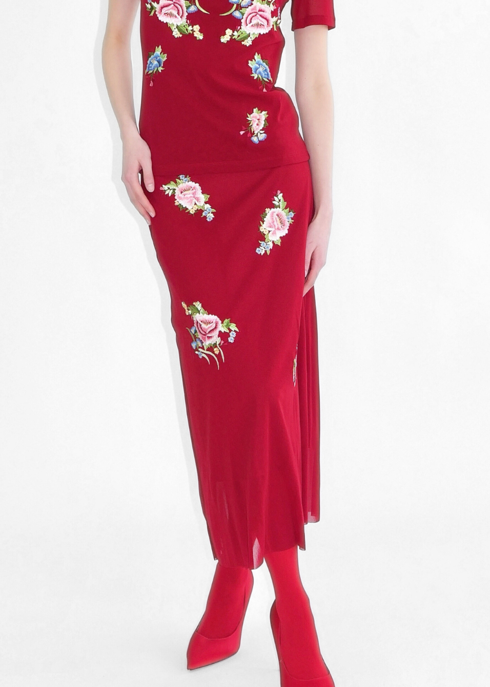 Red dress with floral embroidery on a white background