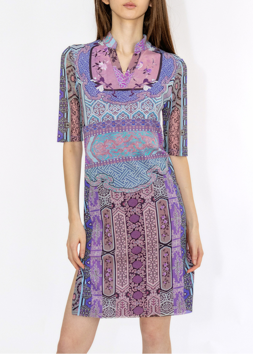 Woman wearing a patterned dress on a white background