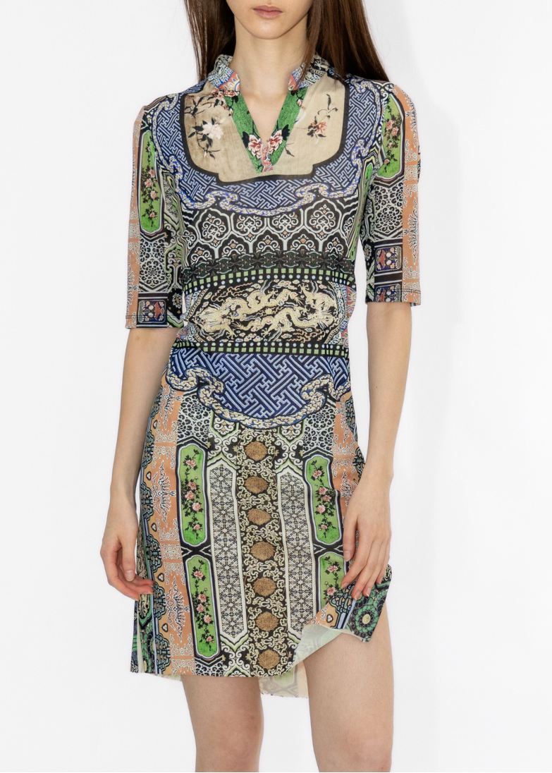 Model wearing a patterned dress on a white background