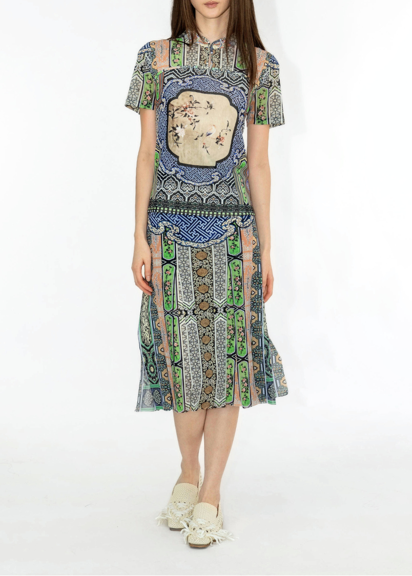 Woman wearing a patterned dress on a white background