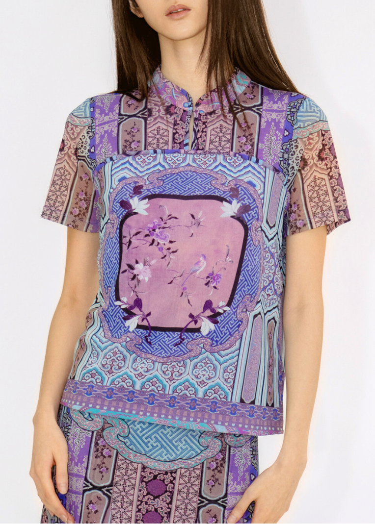 Model wearing a patterned outfit with a white background