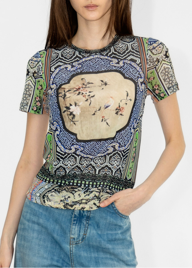 Woman wearing a patterned shirt with a white background