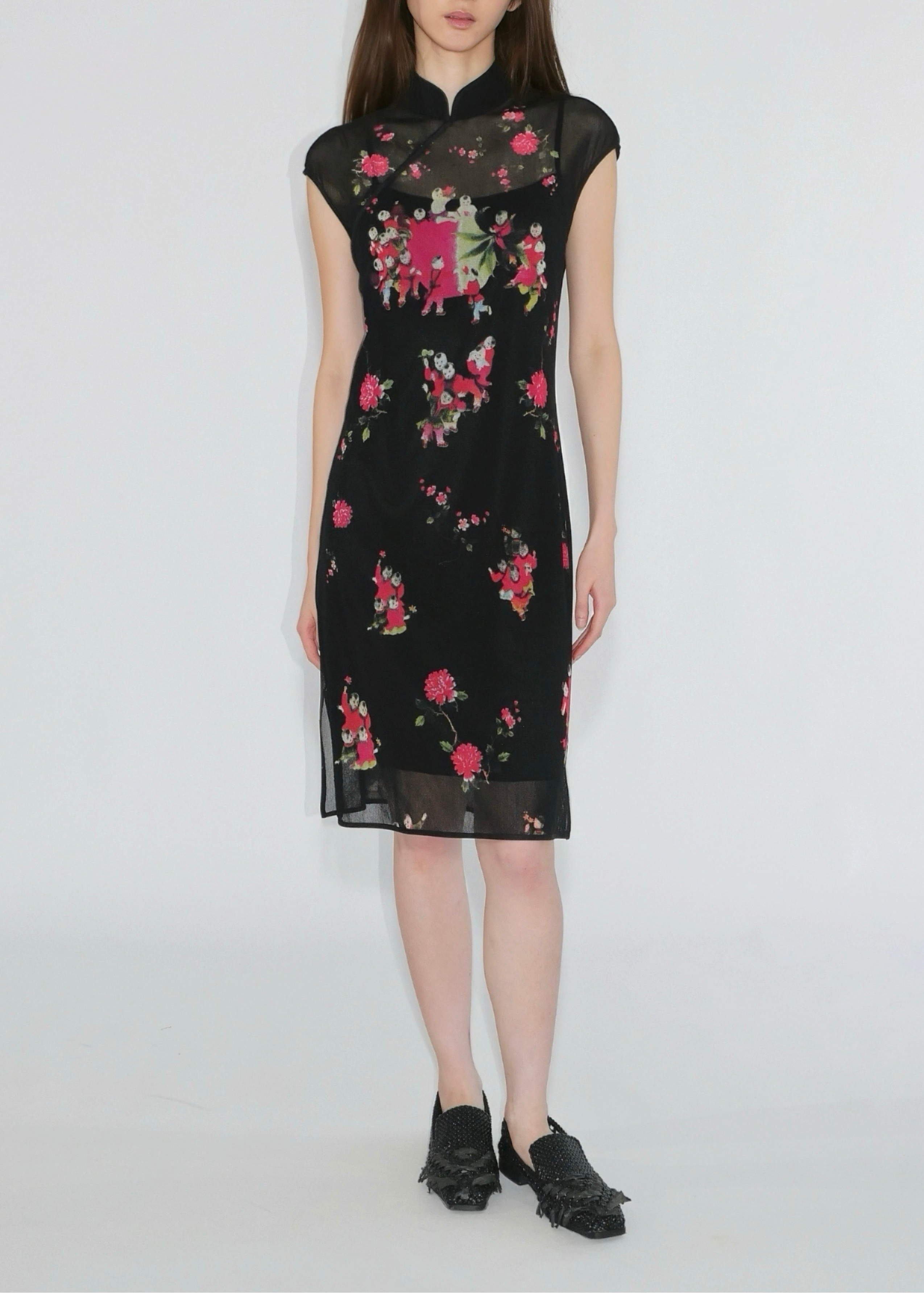 Woman wearing a black floral dress on a white background