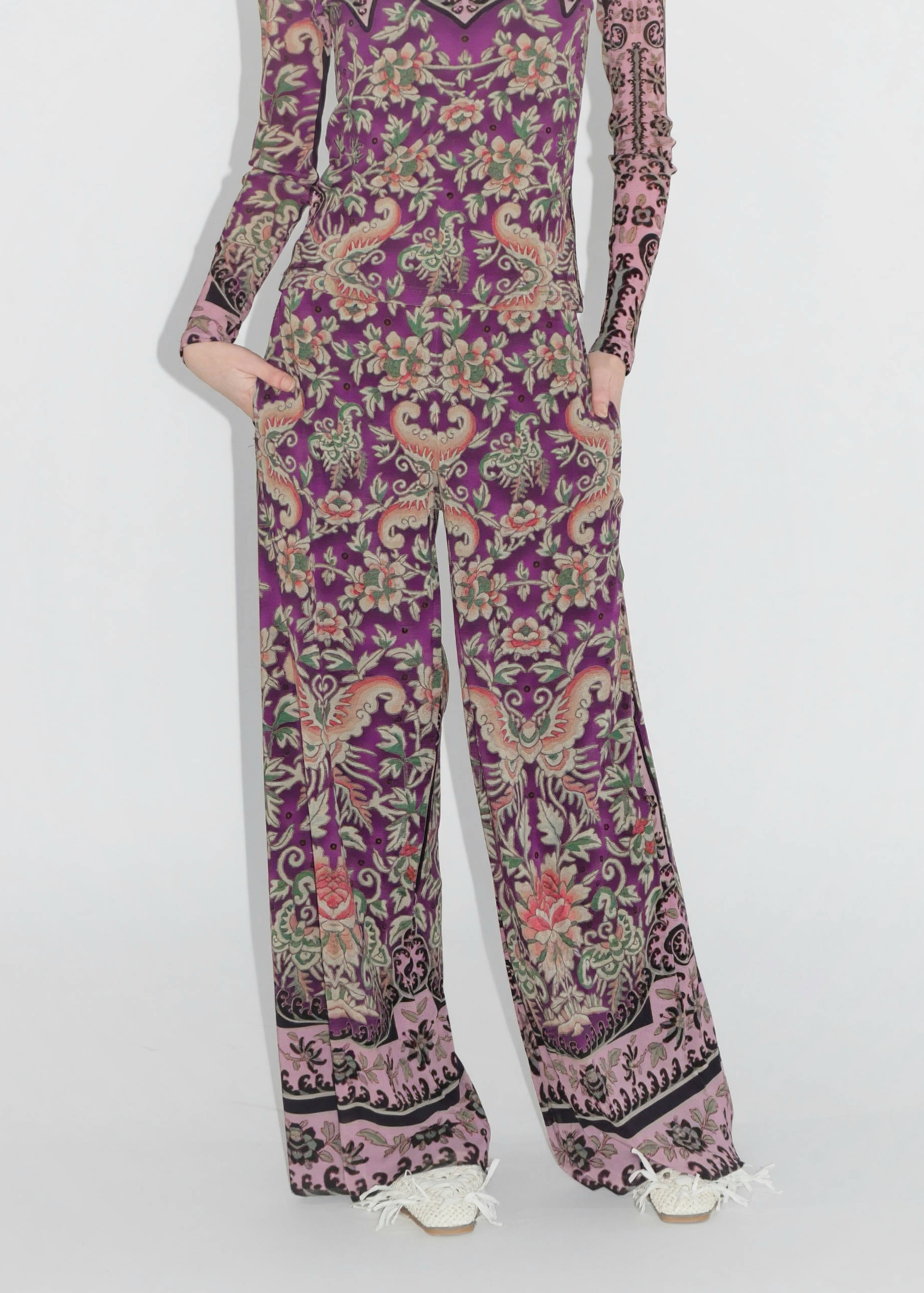 Purple floral patterned jumpsuit on a white background