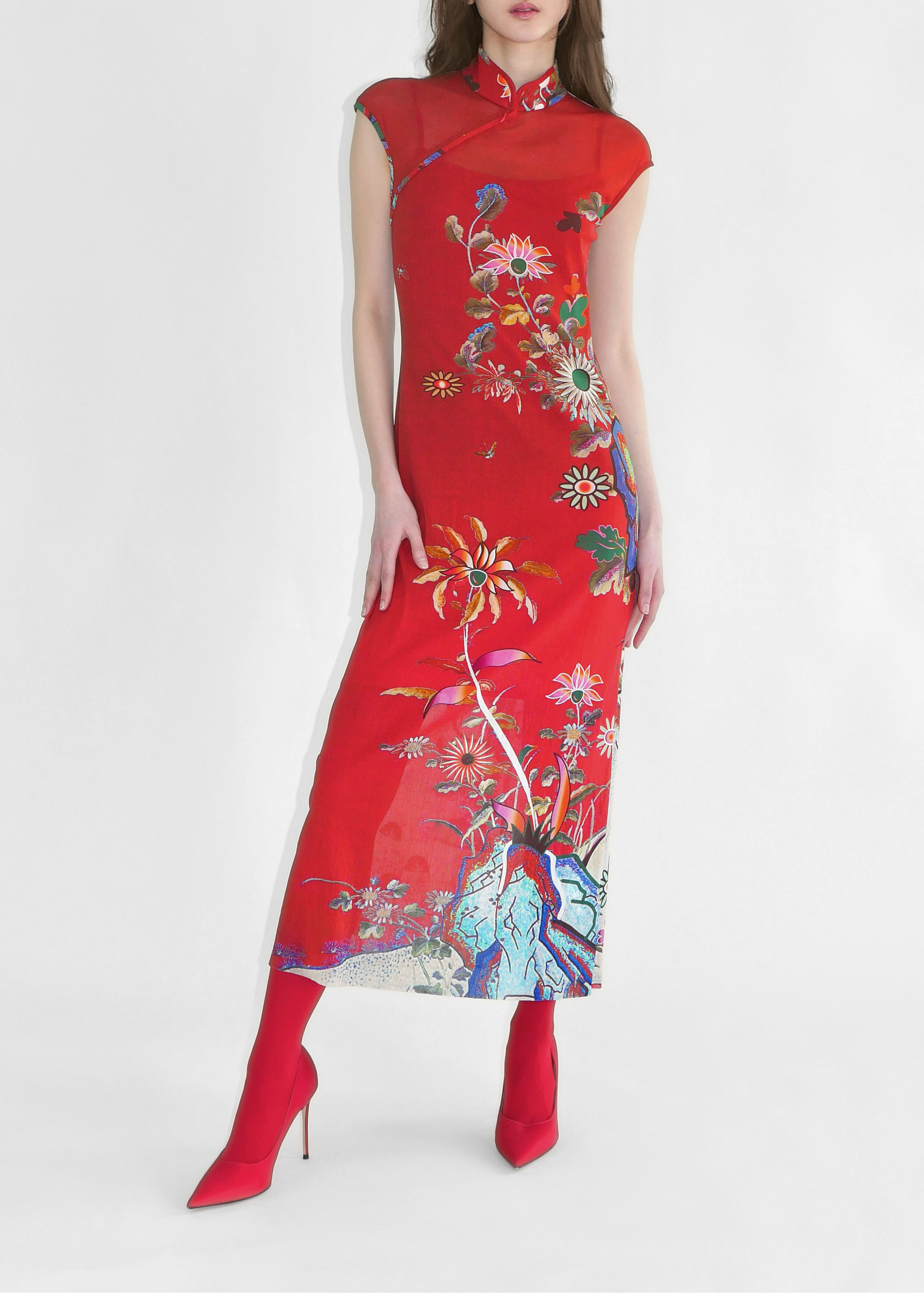 Woman wearing a red floral dress on a white background