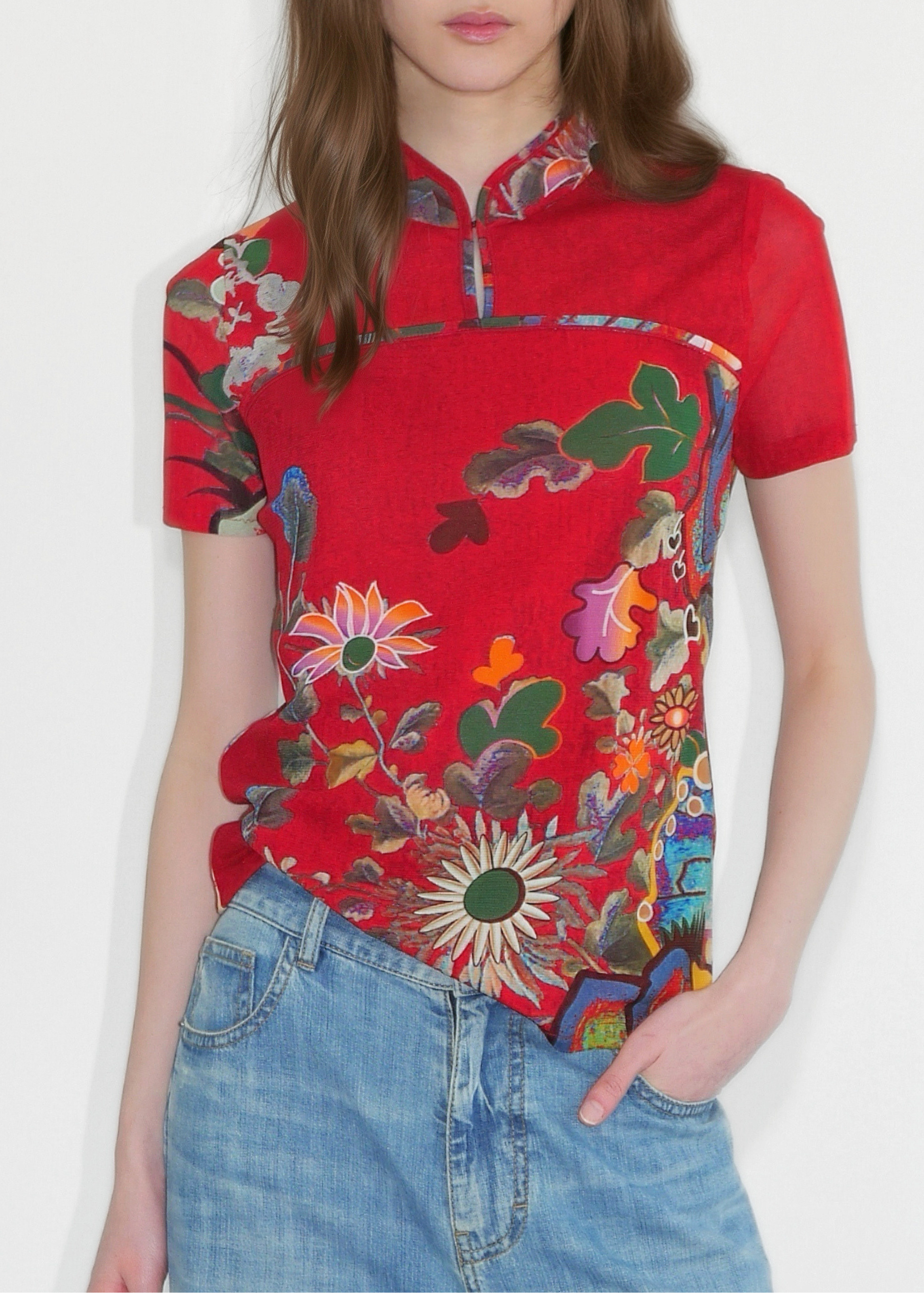 Woman wearing a red floral blouse with a plain background