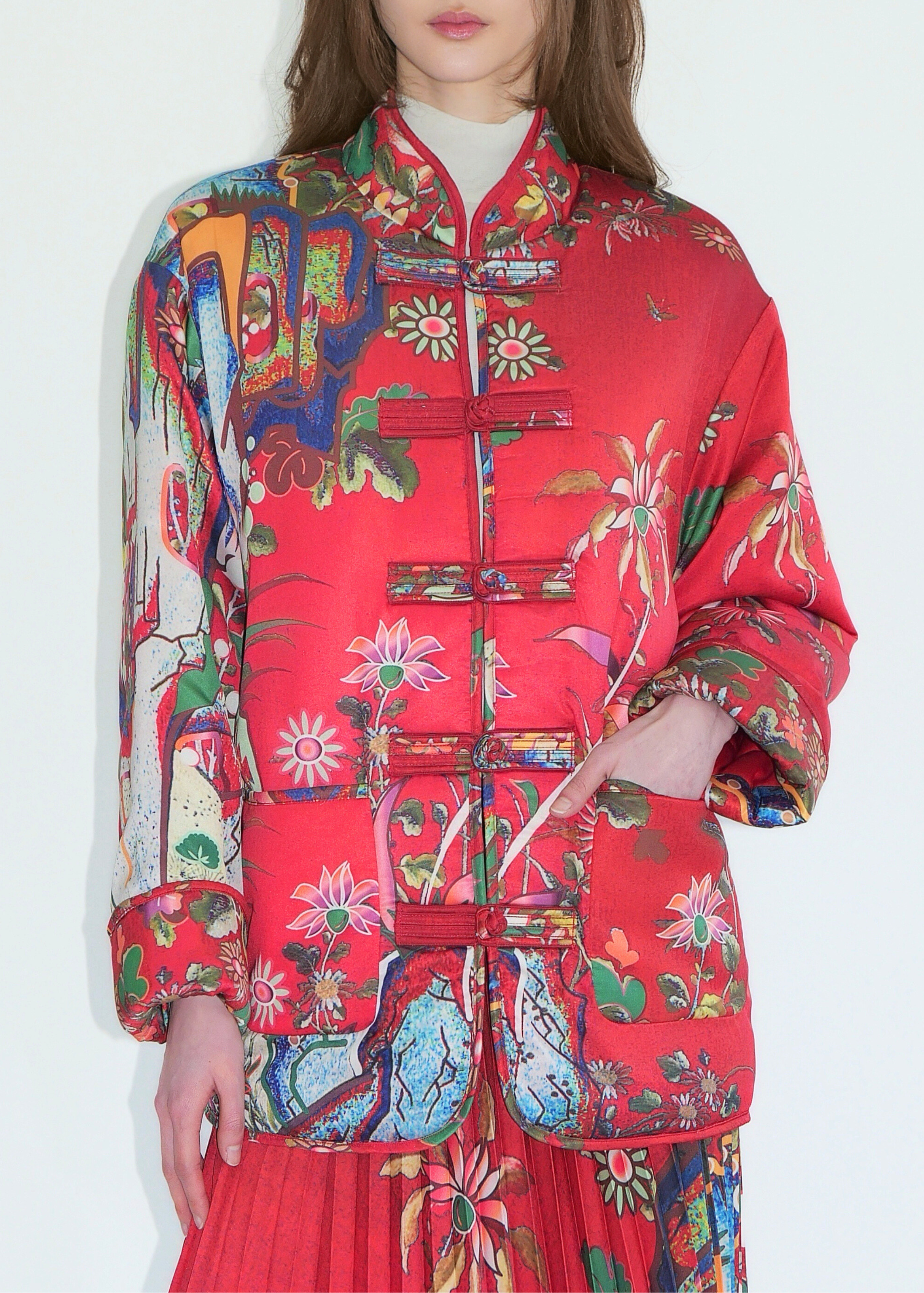 Person wearing a colorful floral jacket on a white background