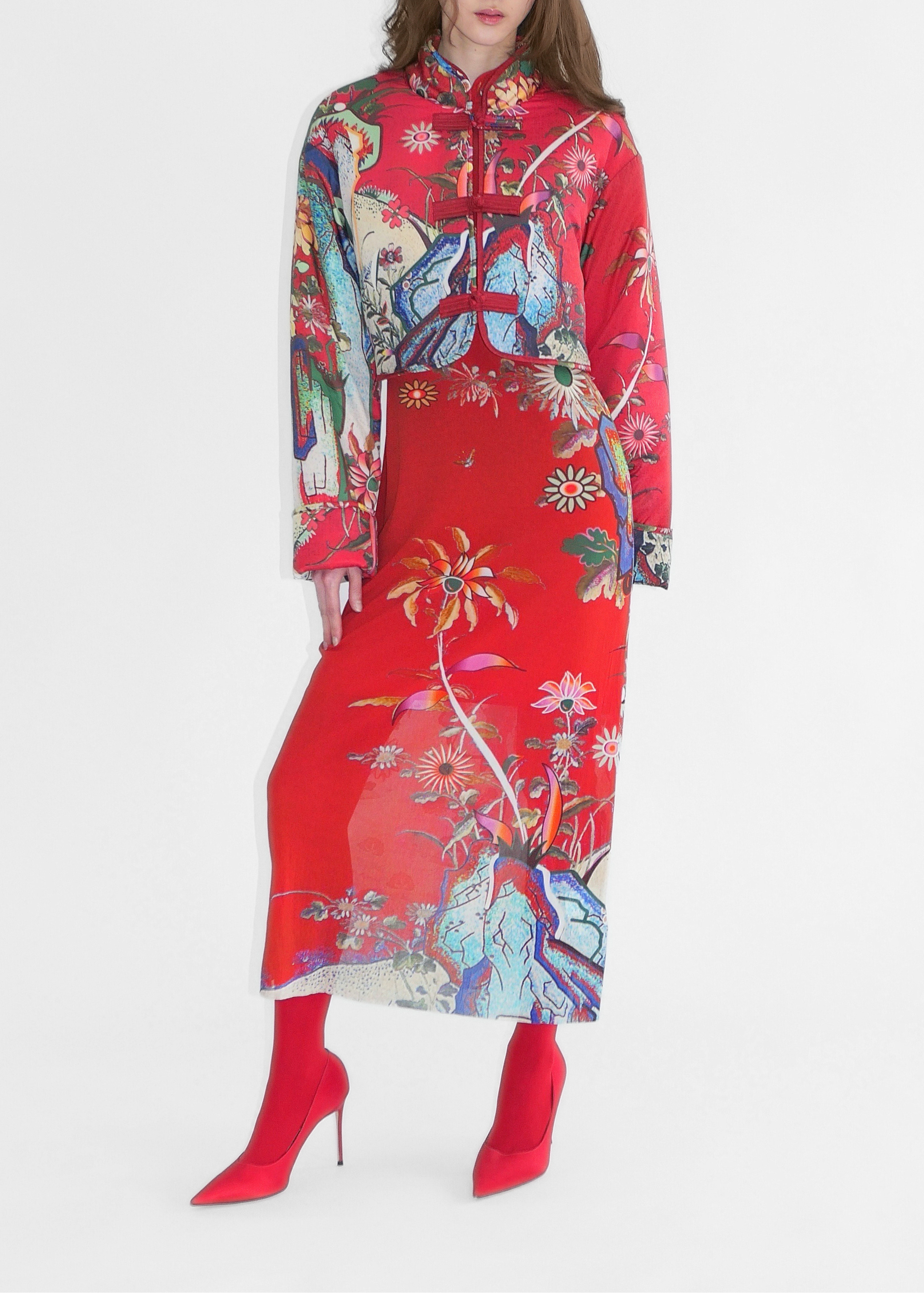 Woman wearing a red floral dress on a white background